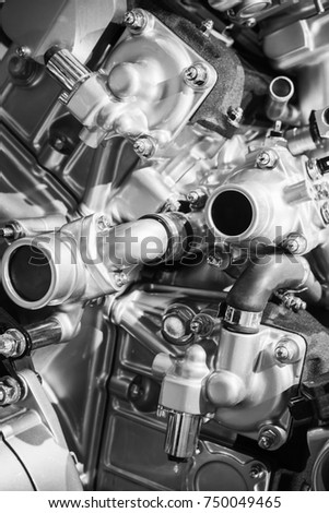 Shiny V12 car engine fragment, closeup photo with selective focus