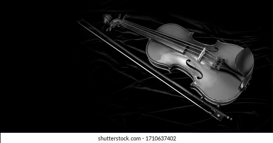 Shiny Violin And Bow Isolated On Black Velvet  Background With Copy Space