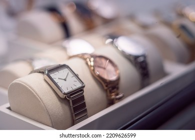 Shiny watches, exposed behind the window of a watch shop - Shutterstock ID 2209626599