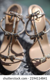 Shiny Wedding Shoes On A Stone Windowsill.