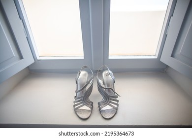 Shiny Wedding Shoes On A Stone Windowsill.