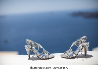 Shiny Wedding Shoes On A Stone Windowsill.