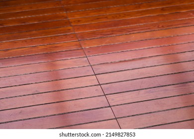 Shiny Yacht Deck Made Of Red Wood Planks, Close Up Photo