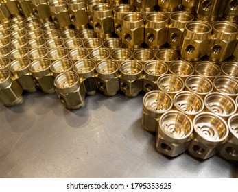 Shiny Yellow Metal Parts Background. Shiny Brass Metal Threaded Hexagonal Parts After Turning And Machining.