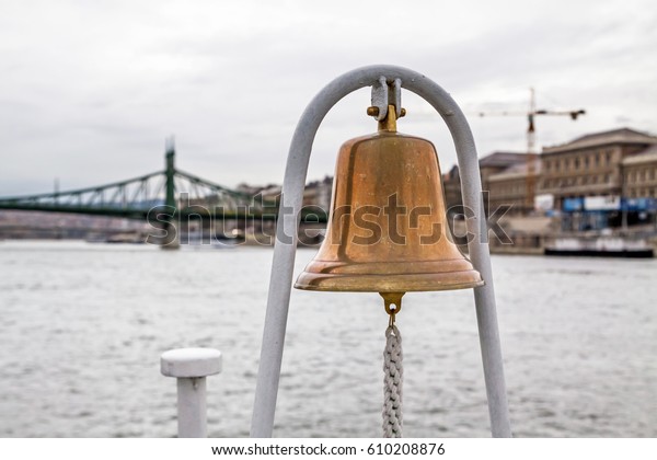 Ship bell with\
Liberty bridge on the\
background