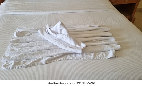 Ship, Boat Folded From White Towels On Bed In An Old Hotel Room, Top View, Turn Down Service