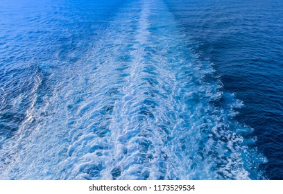 Ship Or Boat Wake In A Tropical Sea Looking Back At A Tropical Holiday Island-concept Of Departure Or Going Home.