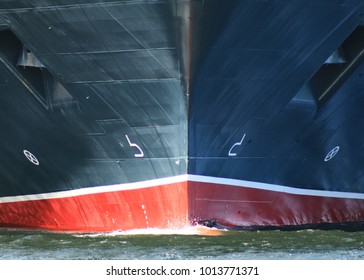 Ship Bow From Dead Ahead With Anchors And Bow Wave. Ship Is Black And Red Hull Showing Anchors On Port And Starboard Sides