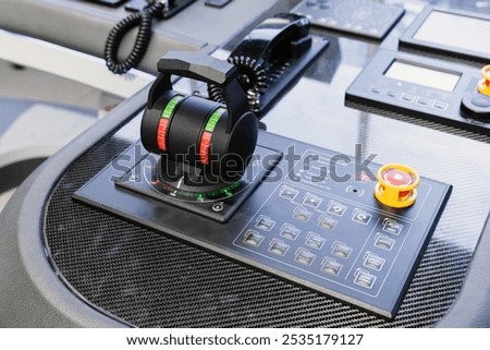 Ship control panel with an engine accelerator and buttons, close-up photo. Electronic equipment of marine navigation simulation system