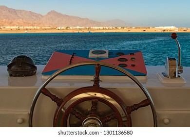 Ship control panel with steering wheel and engine accelerators on the captain bridge. Red Sea, Sinai Peninsula of Egypt.