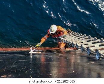 A Ship Crew Is Painting Draft Mark Or Load Line Of A Cargo Ship Or Bulk Carrier