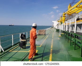 A Ship Crew Is Using High Pressure Washer To Wash On Ship Main Deck. Hydro Blast.