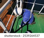 a ship crew is working or chipping during maintenance period on a cargo ship