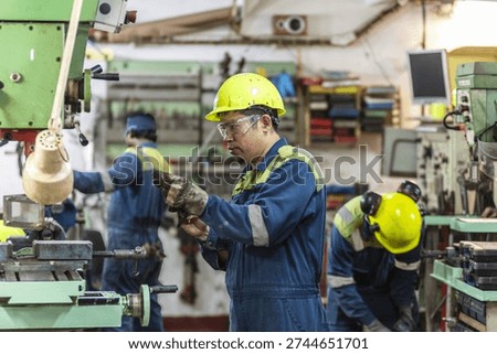 Ship engineering crew in machinery workshop, teamwork at sea.