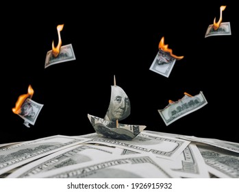 Ship from a hundred dollar bill with a portrait of Benjamin Franklin on sail. The concept of the financial market, exchange rates, success amidst crisis, devaluation and bankruptcy. Burning bills.