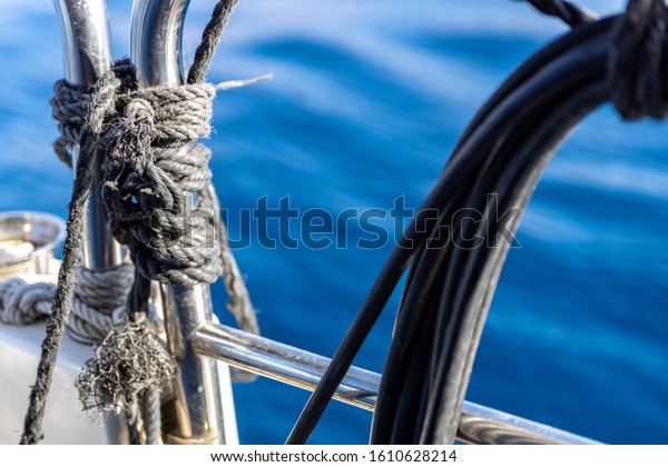 Ship items consisting of chrome railings and\
ropes on a ship against the blue\
sea