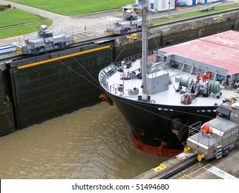 Ship In The Panama Channel Lock Centered By Two Locomotives