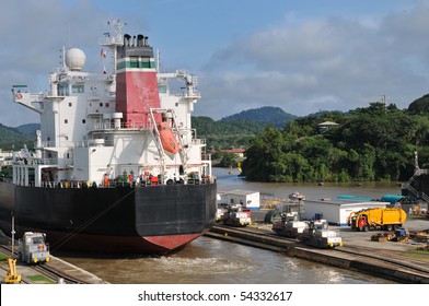 Ship In The Panama Channel Lock Centered By The Locomotive