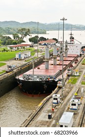 Ship In The Panama Channel Lock Centered By Locomotives