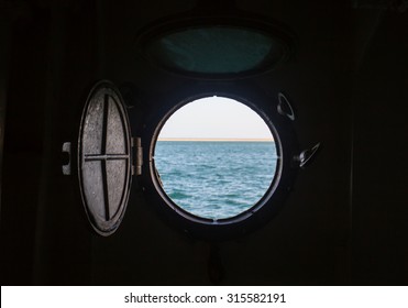ship porthole on wooden wall