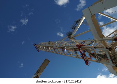 Ship Radar On Navigational Bridge And Cream Color Gantry Crane In Vertical Position Under Blue Sky With Small White Clouds. In The Picture Is A Lot Of Copy Space.