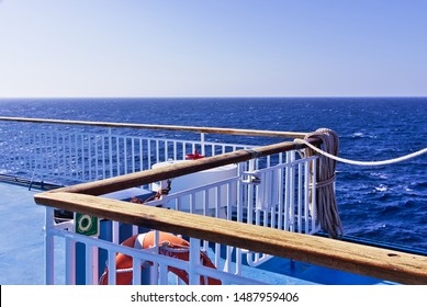 Ship railing and deck while wailing on open sea.