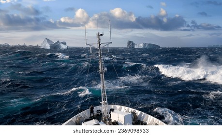 Ship rolling in heavy seas near icebergs in Scoresbysund on the east coast of Greenland. - Powered by Shutterstock