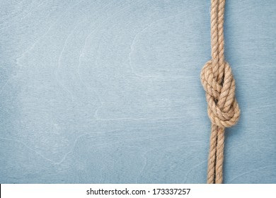 Ship Rope Knot On Blue Wooden Texture Background