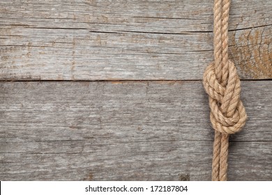 Ship Rope Knot On Old Wooden Texture Background