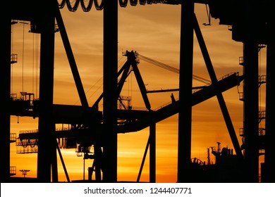 Ship to shore container cranes at sun rise 