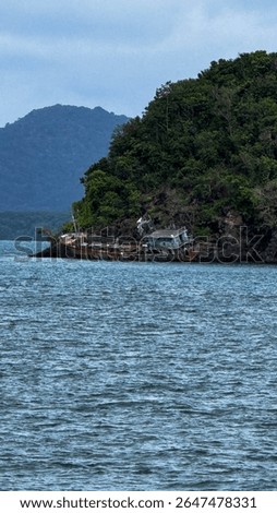 A ship stranded on the island by a storm that blew it onto a mountain.