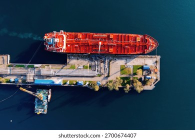 Ship tanker with LPG. Process of loading of tanker, drone aerial top view.