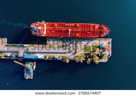 Ship tanker with LPG. Process of loading of tanker, drone aerial top view.