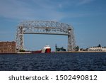 A Ship Traveling Under A Lift Bridge