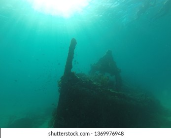 Ship Wreck In Barbados With Sun From Above And Corals Grown Over It