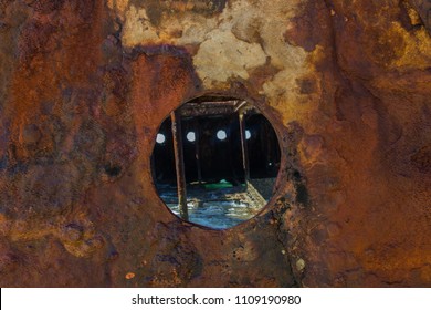 Ship Wreck On The Beach With Blue Torquoise Water Looking Through The Port Hole