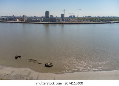 Ship wreck in the river Scheldt with the city of Antwerp in the background. Drone aerial shot seen from above view