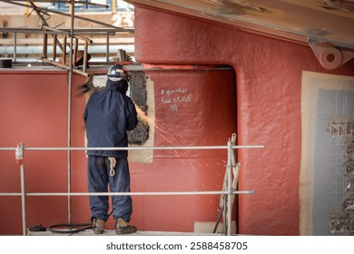 A ship yard worker is working on a ship propeller during dry docking.