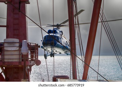 Ship-based helicopter, seaworthy helicopter. Helicopter takes off from deck of icebreaker with goal of landing explorers