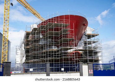 Shipbuilding and crane during ferry construction surrounded by scaffold - Powered by Shutterstock