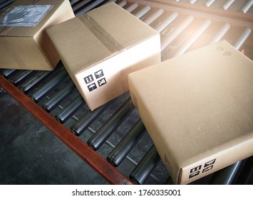 Shipment boxes sorting on conveyor belt at distribution warehouse.
