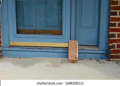 Shipping Box On A Porch Propped Up Against The Front Door