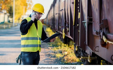 Shipping By Rail. Foreman Making Inspection Of Cargo In The Freight Wagon. Transportation Concept