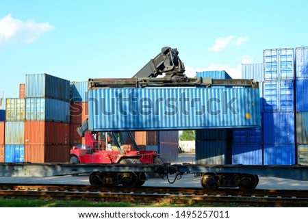 Shipping container loading by richtracker on the freight rail car at logistic warehouse port. Ocean Freight Cargo Shipping, Intermodal Container Freight concept - Image