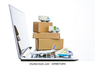 Shipping, delivery and logistic concept. truck car, airplane and cardboard boxes on laptop keyboard. Online technology. 