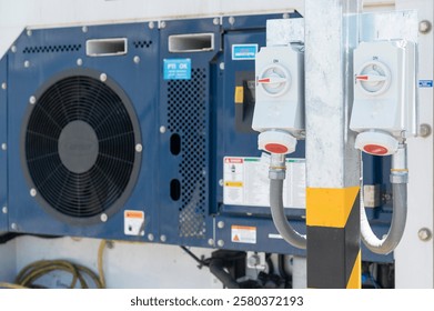 Shipping reefer container with electric socket plug at the port.