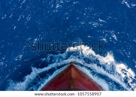 Ship's bow, moving through the waves to her destination. View from forecastle deck.