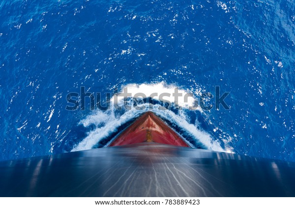 Ship\'s bow, moving through the waves to\
her destination. View from forecastle\
deck.