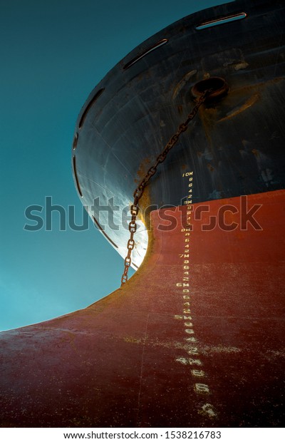 Ship\'s bow with red waterline against the blue\
sky. World shipping freight\
concept