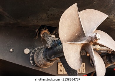 The ship's bronze propeller on the propeller shaft at the stern of the ship.